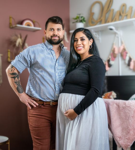 Couple standing in child's nursery