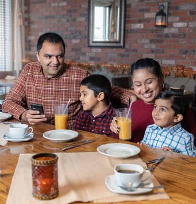 Parents and young children sitting in a restaurant