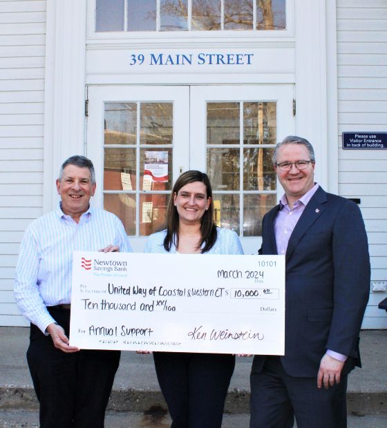 Bank President & CEO and Community & Government Relations Officer presenting check to United Way