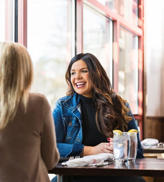 Woman looking out window at restaurant 