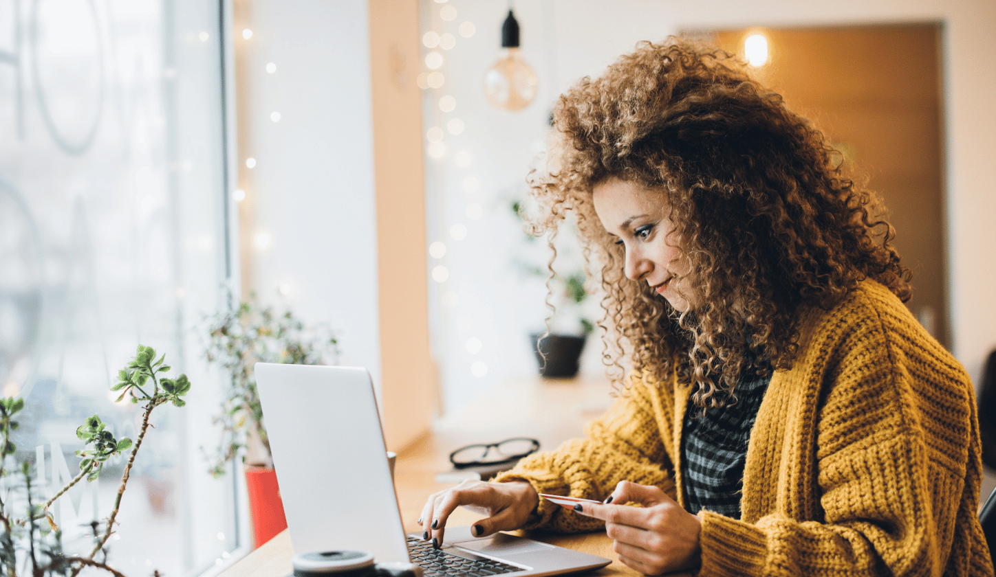 woman online shopping on computer with card