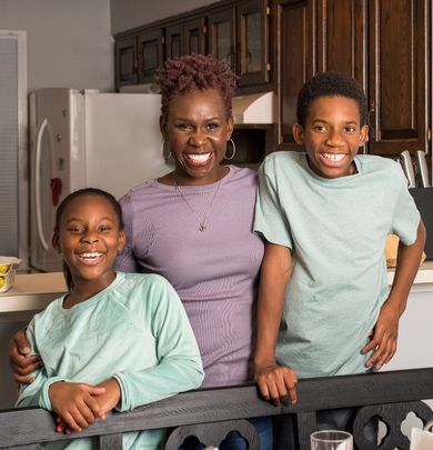 Mother and children standing at the kitchen table