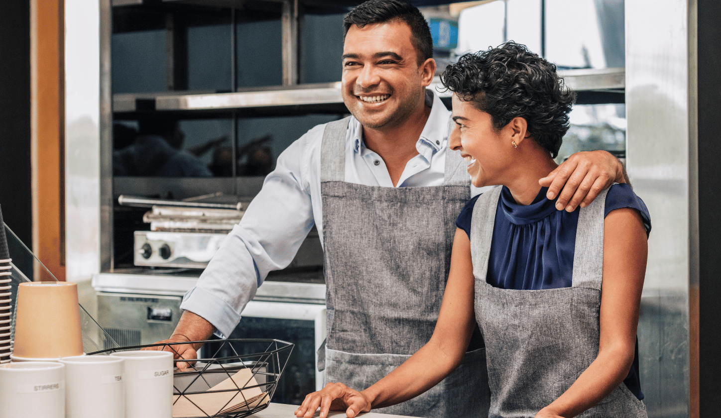 people working at a bakery with aprons