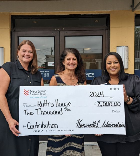 Employees presenting check to Ruth's House