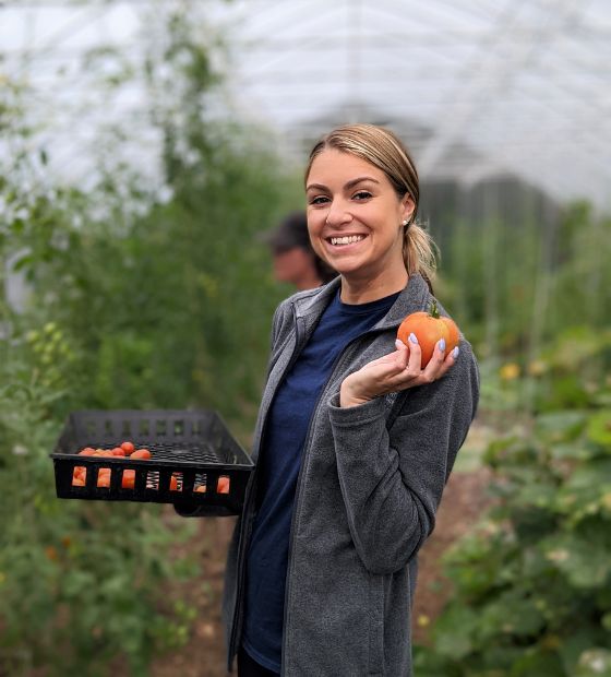 Employee holding a tomato