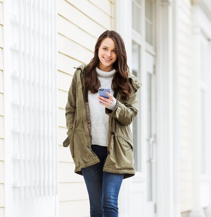 Young woman walking and on her phone