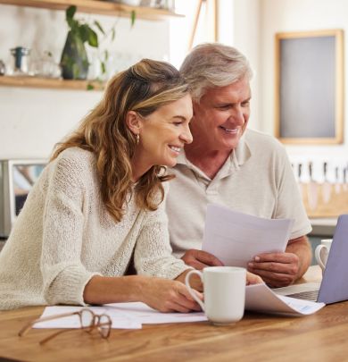 Man and woman looking at laptop and smiling