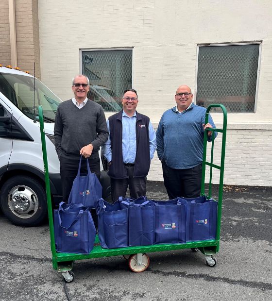 employees with bags of donated food