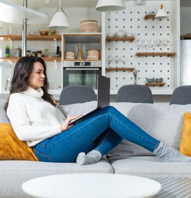 woman sitting on couch on laptop