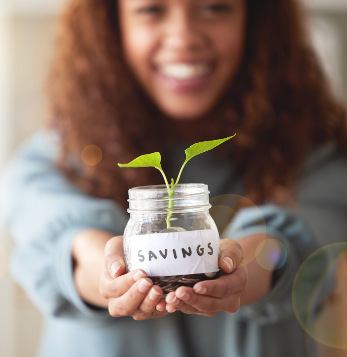 woman holding plant labeled savings