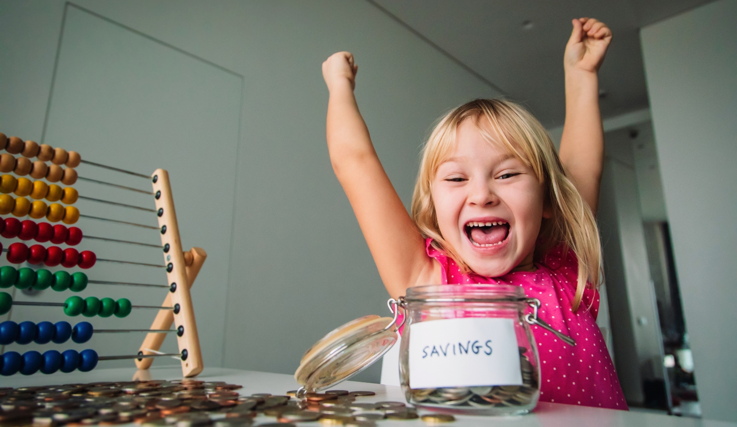 Young girl celebrating saving money
