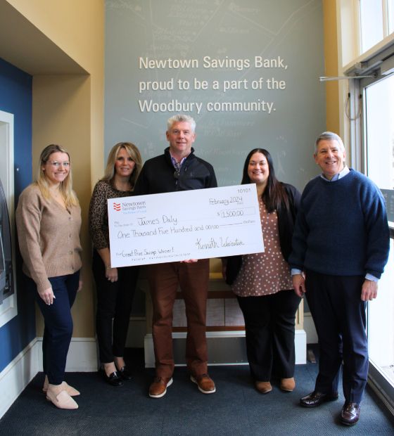 Bank President and staff presenting check to Great Prize Savings Winner