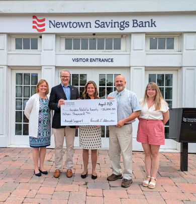 employees presenting check to habitat for humanity at bank