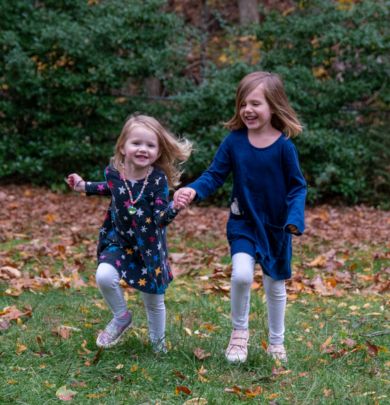 Two little girls playing outside